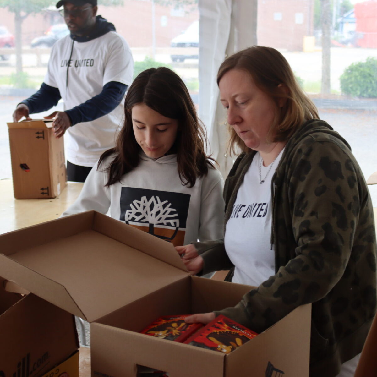 Volunteers sort books.