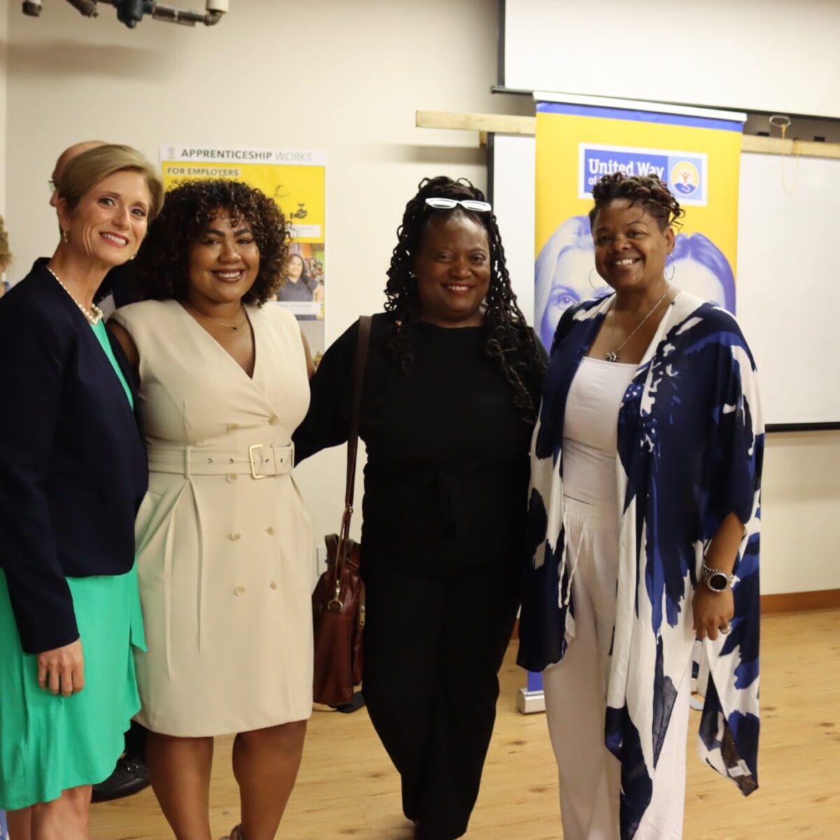 Cortney Nicolato, president and CEO of United Way of Rhode Island, posing with Karla Alba, Adama Brown, and Lauren Nance.