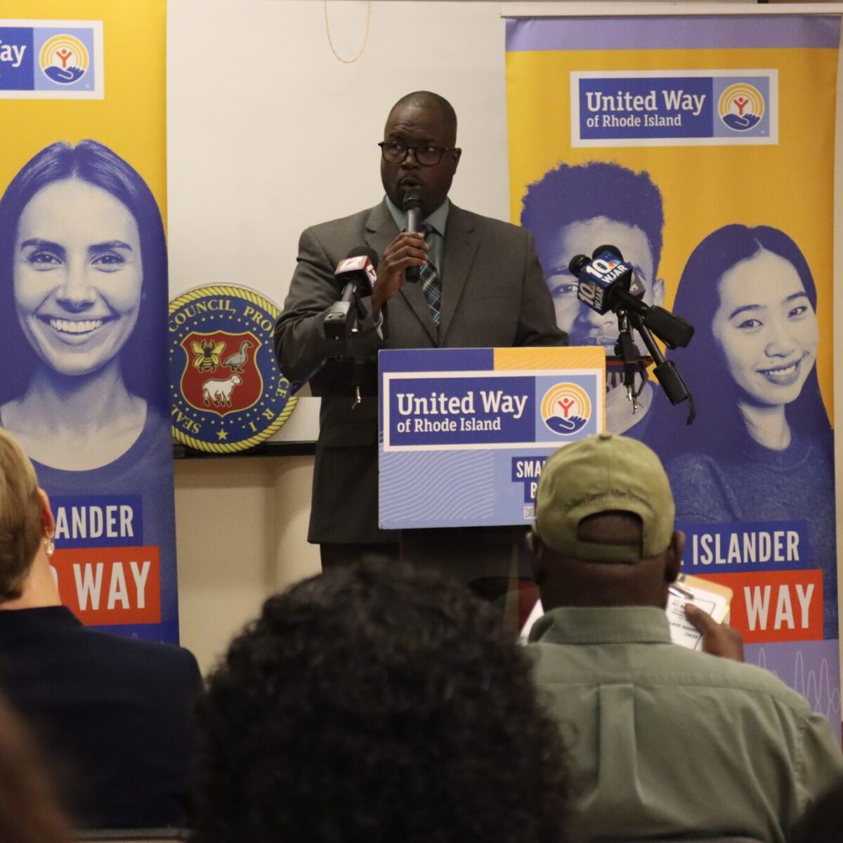 Larry Warner, DrPH, chief impact and equity officer for United Way of Rhode Island, speaking from a podium.