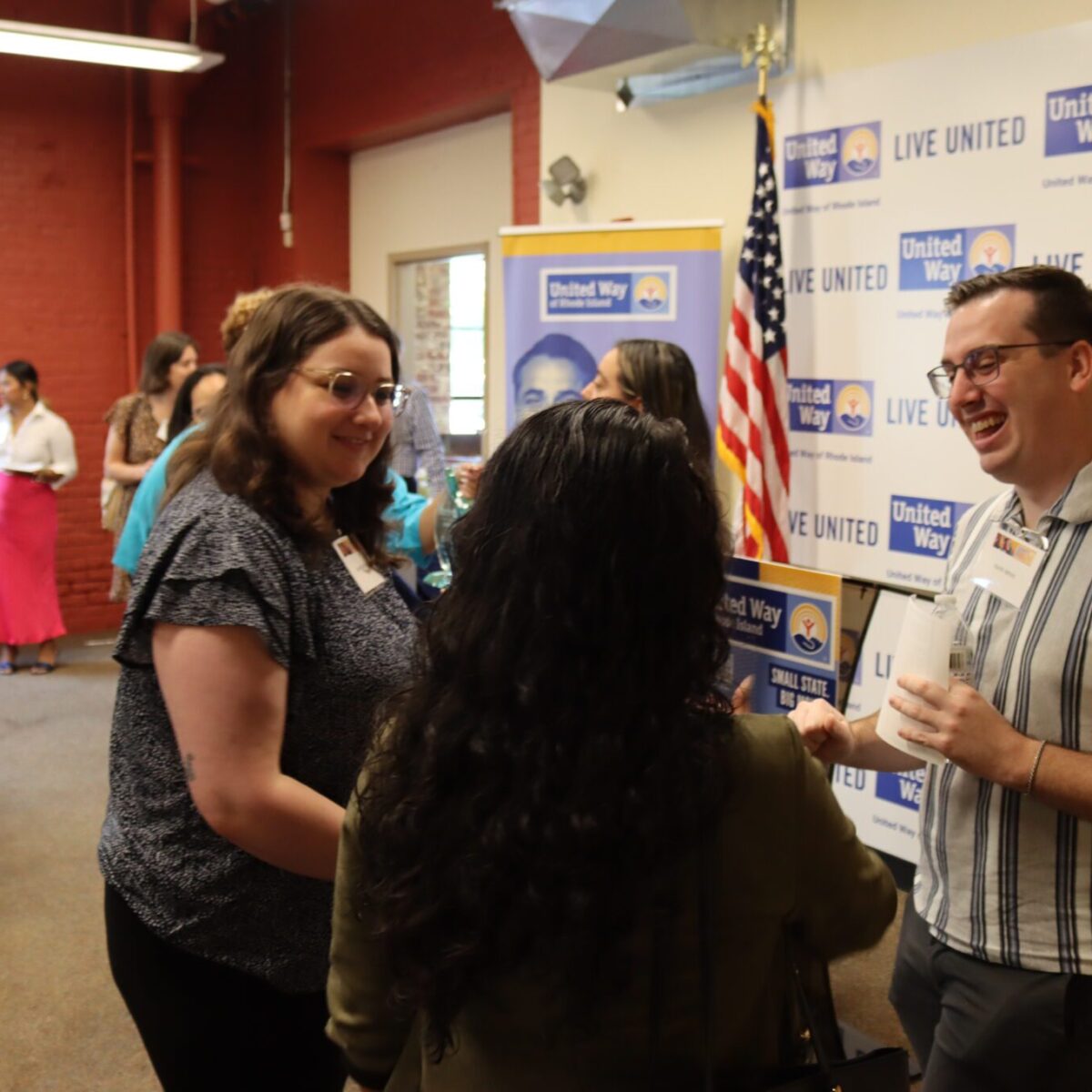 Justice Assistance's Lauren Holly and Keith Whitt engaging with another event participant.