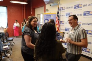 Justice Assistance's Lauren Holly and Keith Whitt engaging with another event participant.