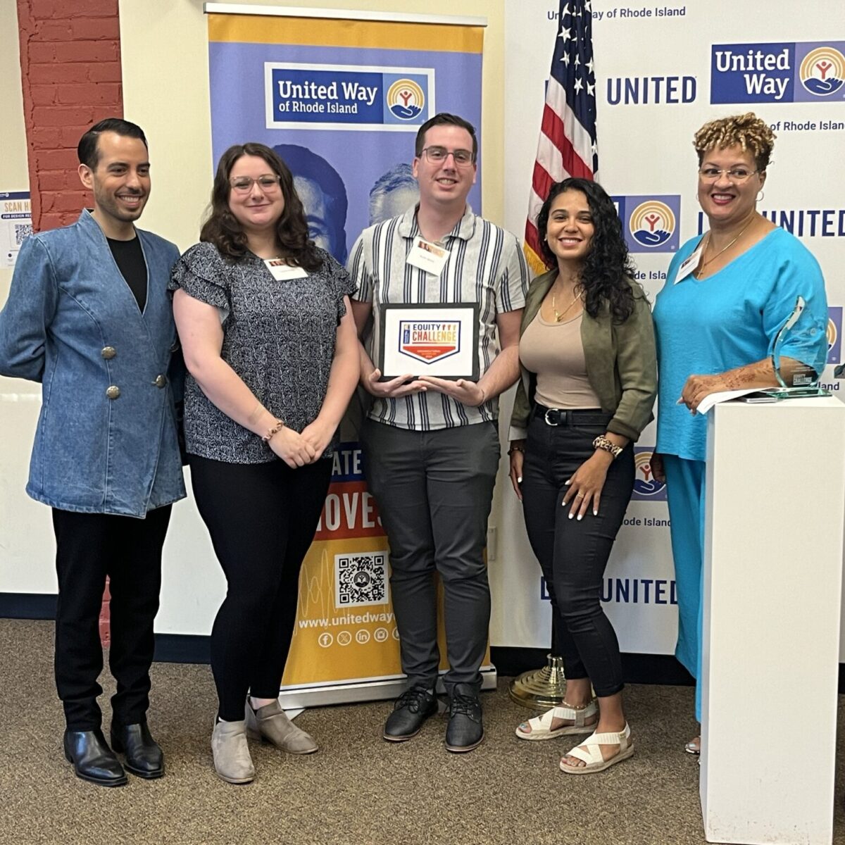 United Way of Rhode Island's Kevin Matta and Lifespan's Christin Zollicoffer posing with three Justice Assistance staff.