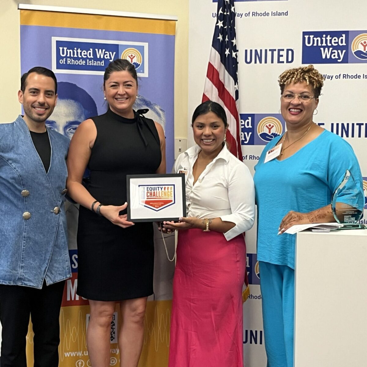 United Way of Rhode Island's Kevin Matta and Lifespan's Christin Zollicoffer posing with Conexión Latina Newport staff.