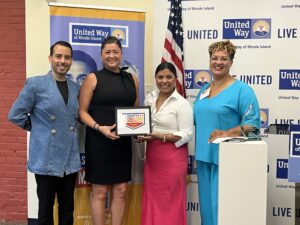 United Way of Rhode Island's Kevin Matta and Lifespan's Christin Zollicoffer posing with Conexión Latina Newport staff.