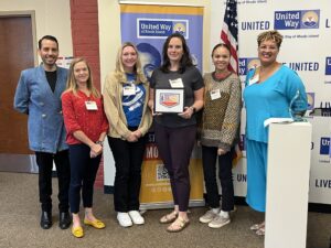 United Way of Rhode Island's Kevin Matta and Lifespan's Christin Zollicoffer with four Girls on the Run Rhode Island staff.